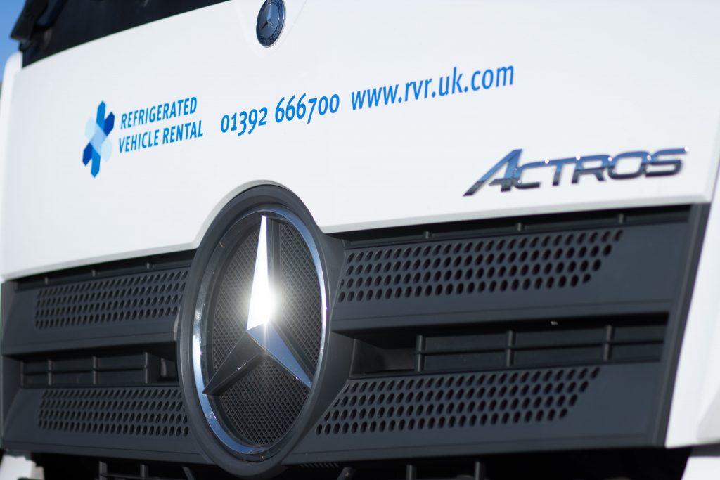 A close-up of the front of a Mercedes refrigerated vehicle with the RVR logo.
