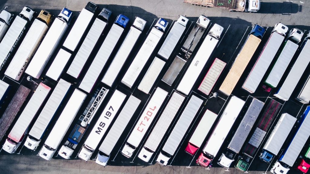 Birds eye view of lorries parked in a car park.
