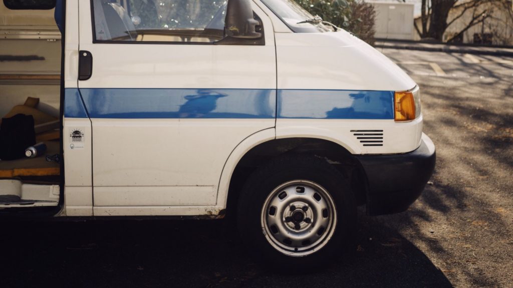 A white van with a blue stripe.