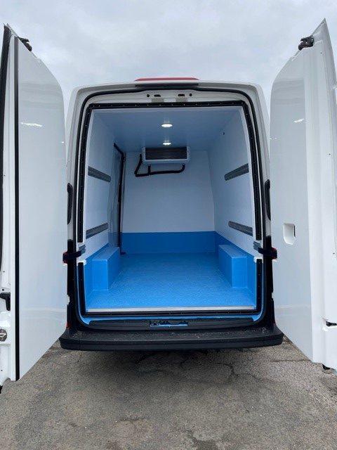 Refrigerated van with rear doors open.